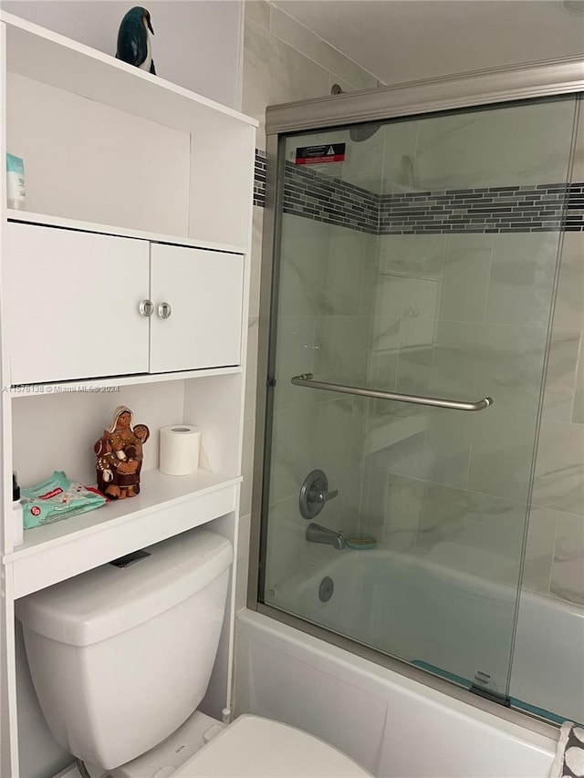 bathroom featuring toilet and enclosed tub / shower combo