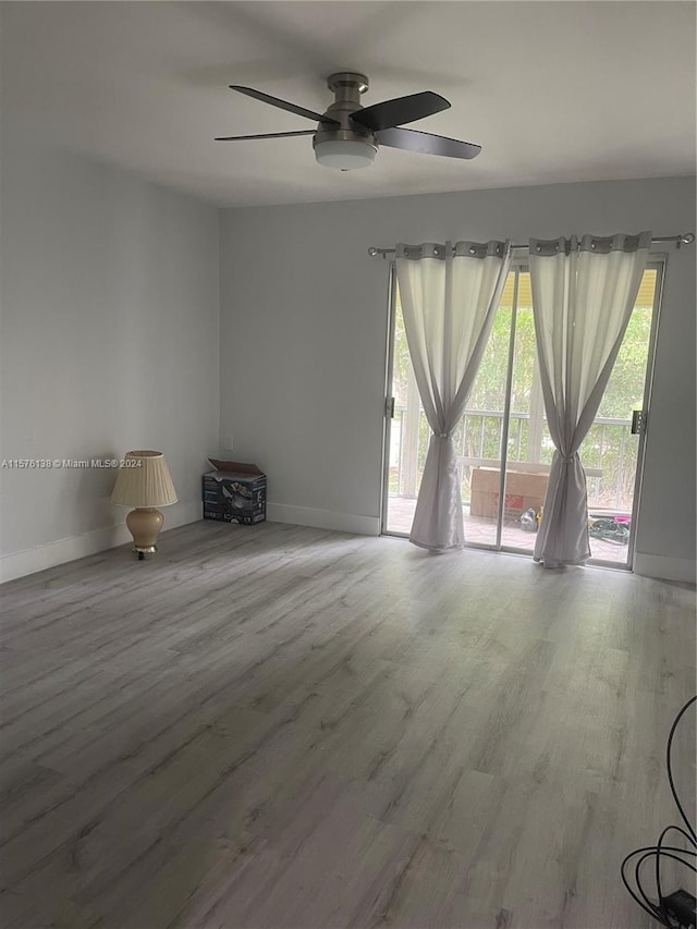 spare room featuring wood-type flooring and ceiling fan