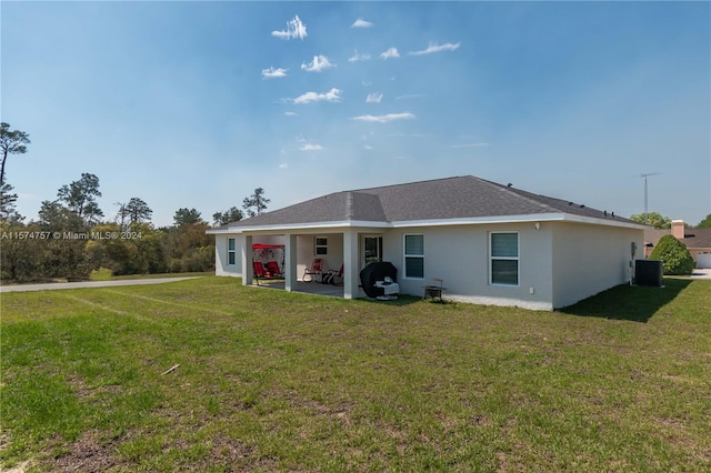 back of house with a patio, a yard, and central AC