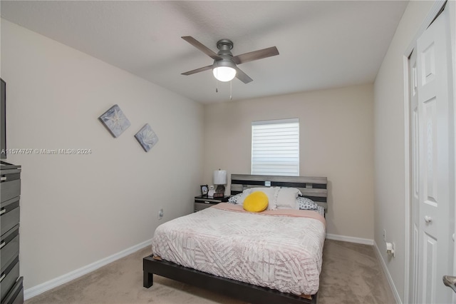 carpeted bedroom featuring a closet and ceiling fan