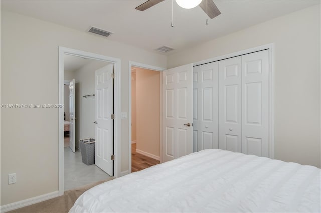 bedroom with a closet, ceiling fan, and light tile flooring