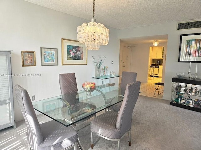 carpeted dining area featuring a chandelier and a textured ceiling