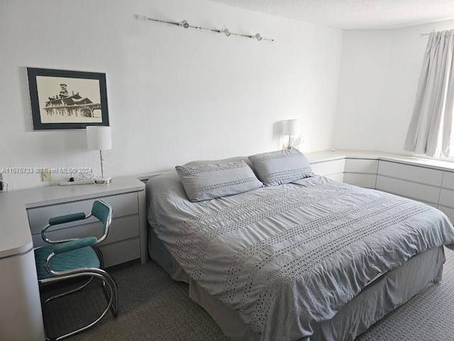 bedroom featuring a textured ceiling and carpet floors