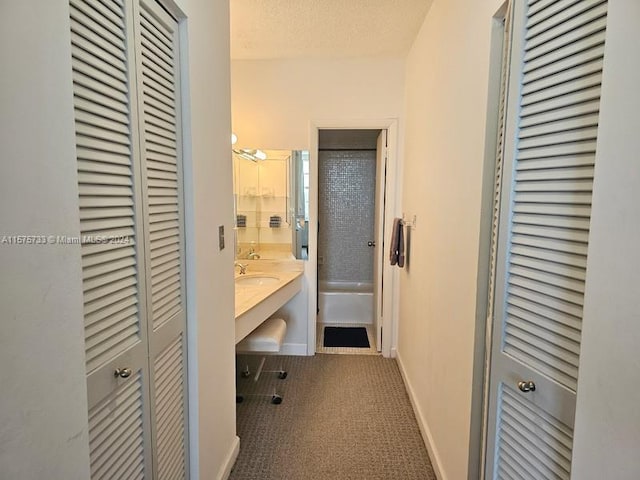 bathroom with tile floors, a textured ceiling, and oversized vanity