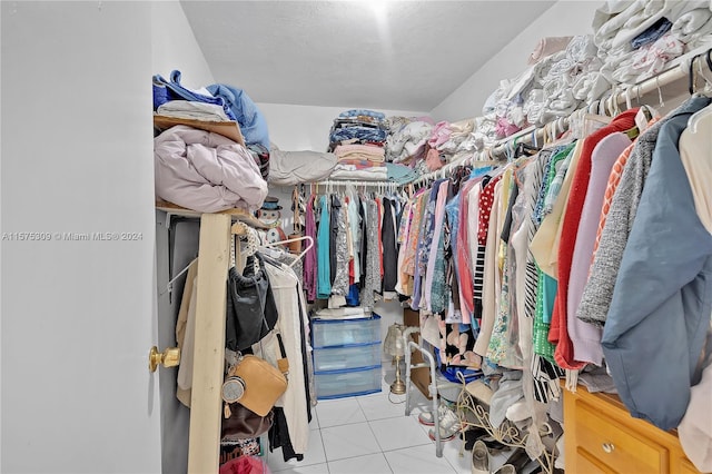 walk in closet featuring light tile floors