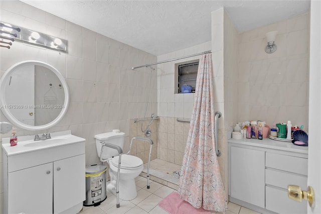 bathroom with vanity with extensive cabinet space, tile floors, tile walls, a shower with shower curtain, and toilet