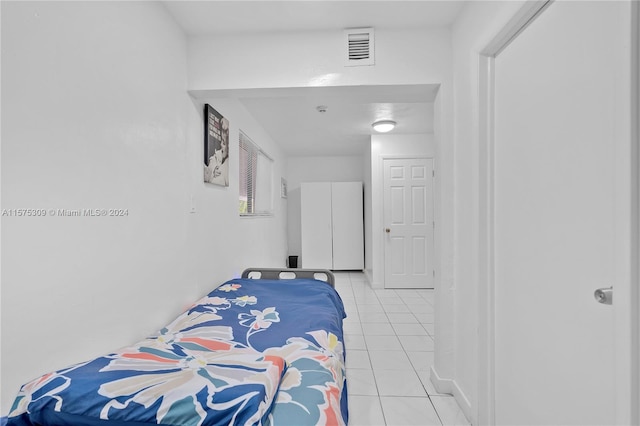 bedroom featuring light tile floors