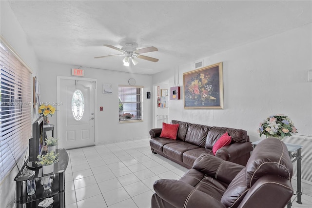 living room featuring ceiling fan and light tile flooring