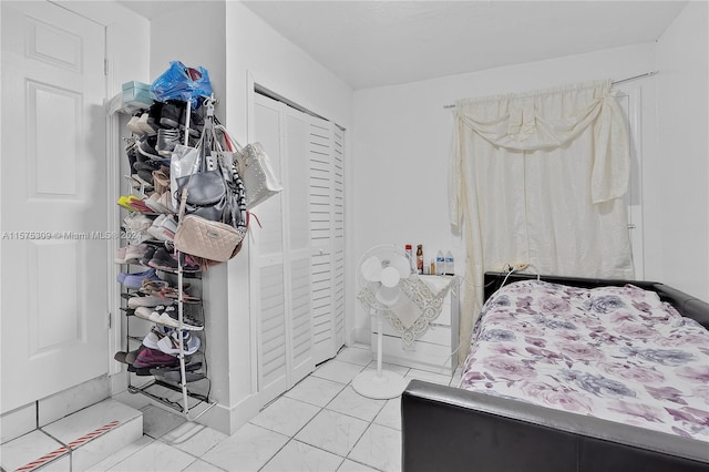 tiled bedroom featuring a closet