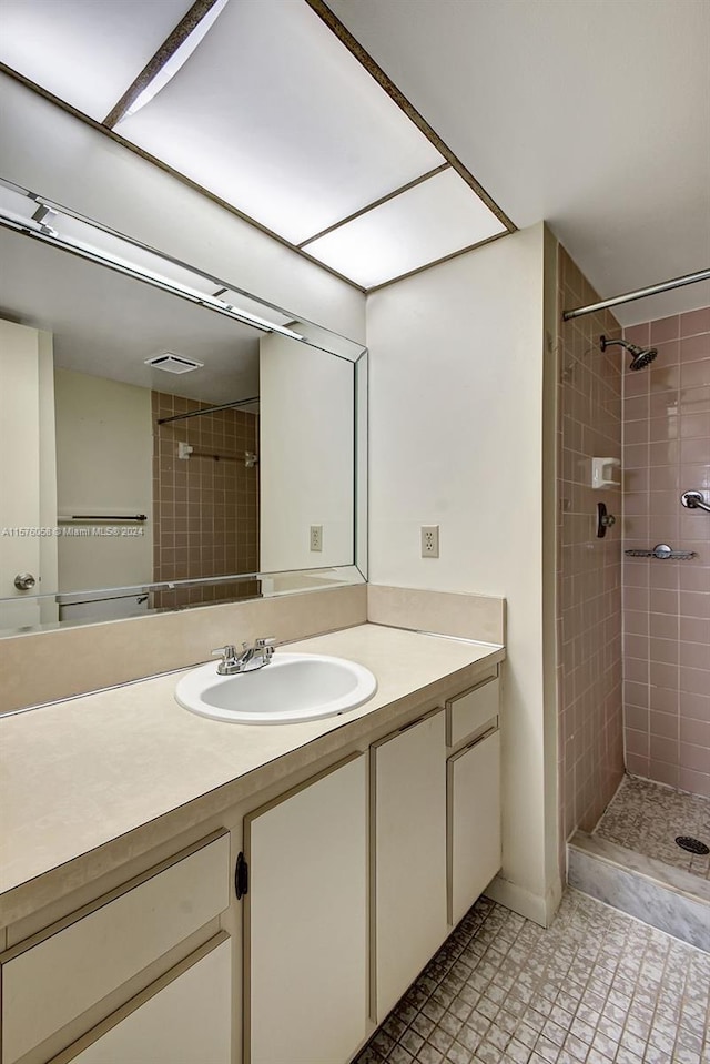 bathroom with vanity and tiled shower