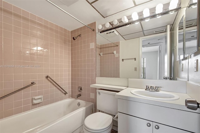 full bathroom with vanity, toilet, and tiled shower / bath combo