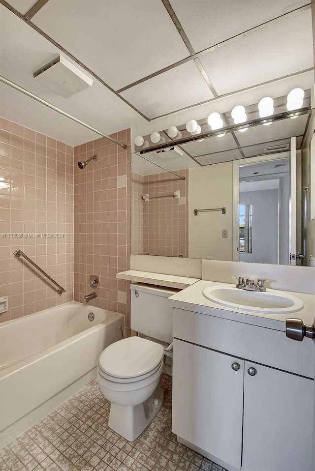 full bathroom with vanity, toilet, and tiled shower / bath combo