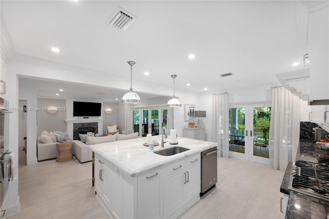 kitchen featuring white cabinets, sink, french doors, and dishwasher