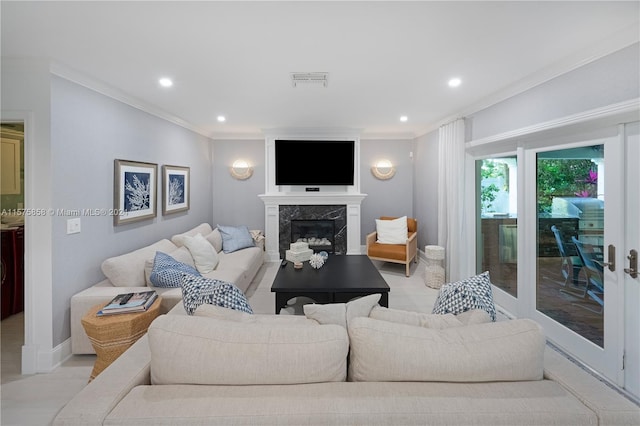 living room with ornamental molding and a fireplace