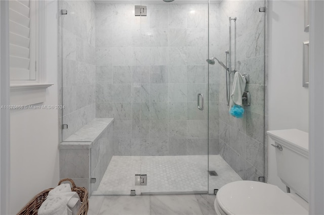 bathroom with an enclosed shower, toilet, and tile floors