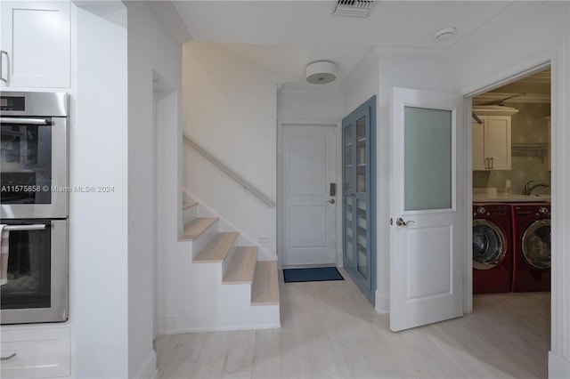 entryway with sink, separate washer and dryer, light hardwood / wood-style floors, and crown molding