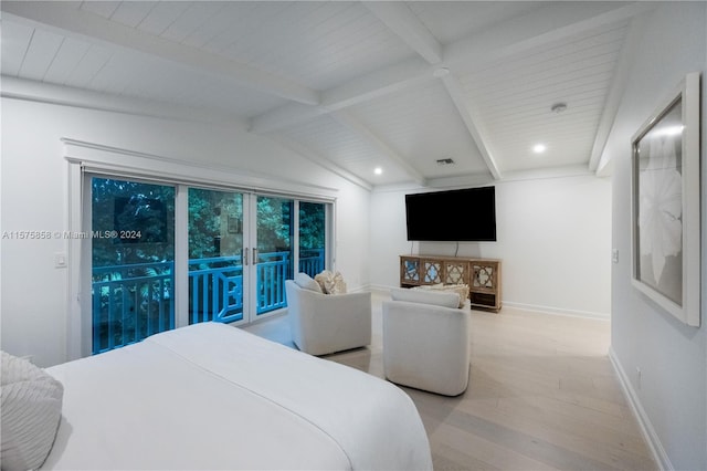 bedroom featuring light hardwood / wood-style flooring, lofted ceiling with beams, and access to exterior