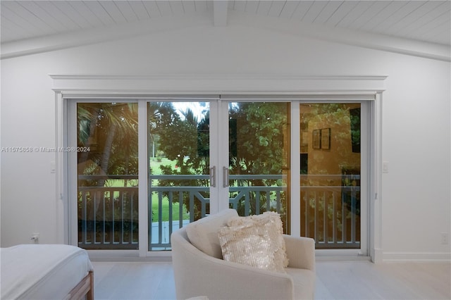 bedroom with french doors, vaulted ceiling with beams, and multiple windows