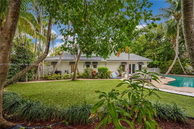 back of house with a patio and a yard