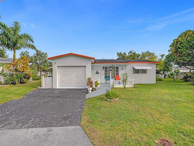 ranch-style house featuring a garage and a front lawn