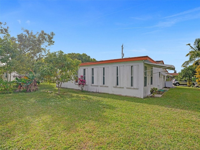 back of house with a lawn