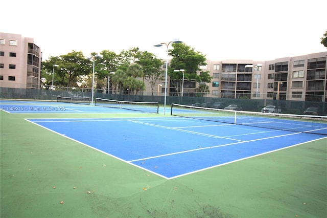 view of sport court featuring fence