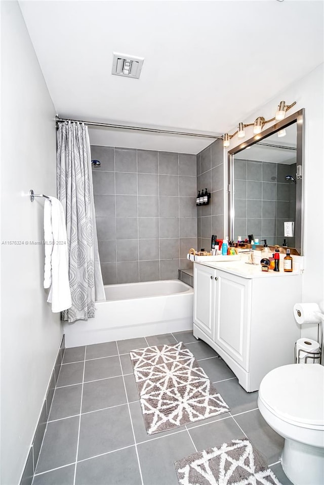 full bathroom featuring tile floors, toilet, large vanity, and shower / bath combination with curtain