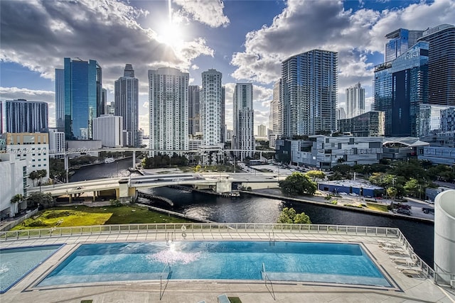 view of swimming pool featuring a water view