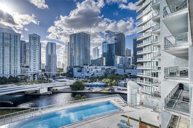 view of swimming pool with a water view