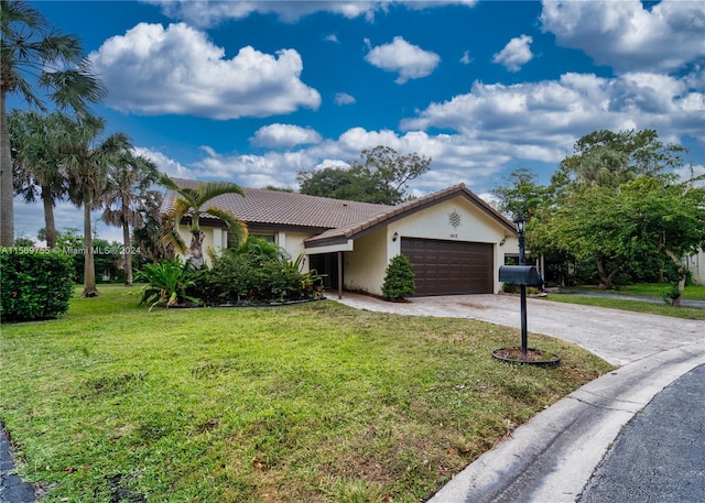 view of front of property with a front yard and a garage