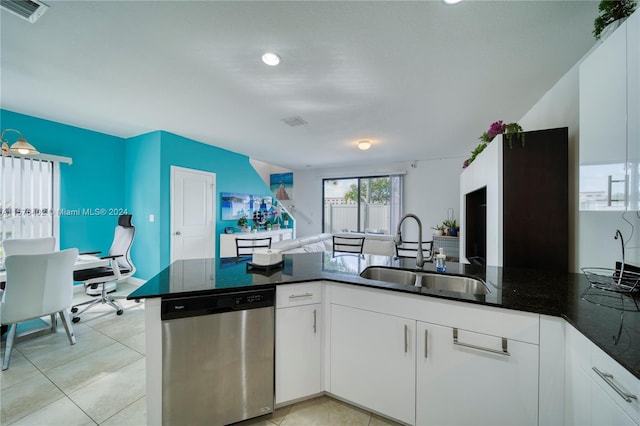 kitchen featuring sink, light tile floors, white cabinets, and stainless steel dishwasher