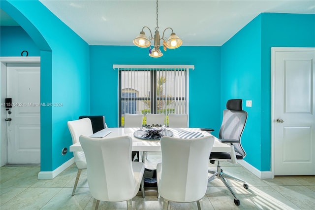 dining room featuring an inviting chandelier and tile floors