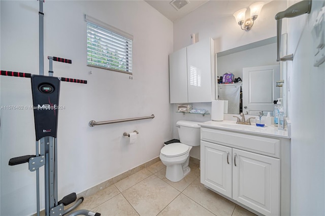 bathroom with vanity with extensive cabinet space, toilet, and tile flooring