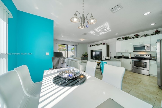 dining room featuring light tile floors and an inviting chandelier