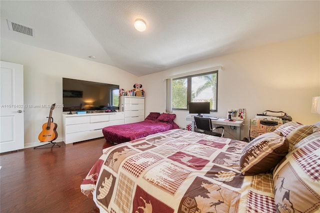 bedroom with lofted ceiling and dark hardwood / wood-style flooring