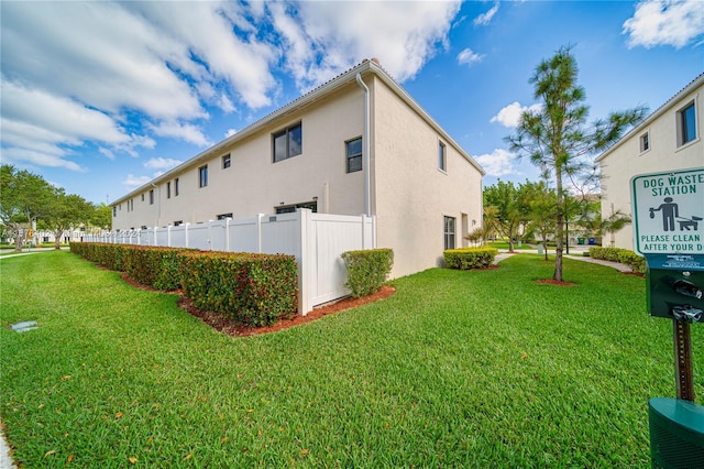 view of side of property with a yard