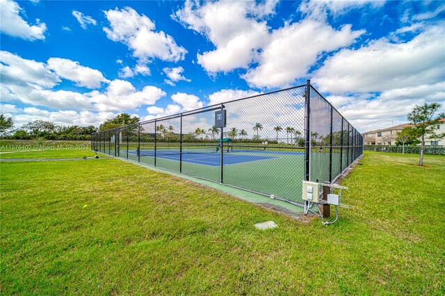 view of sport court featuring a lawn