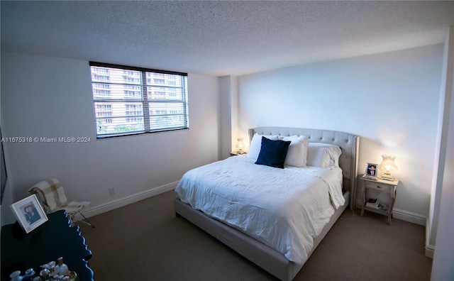 carpeted bedroom featuring a textured ceiling