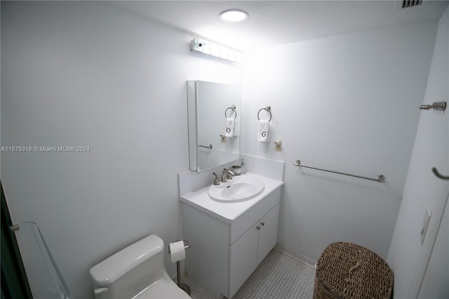 bathroom with vanity, toilet, and tile flooring