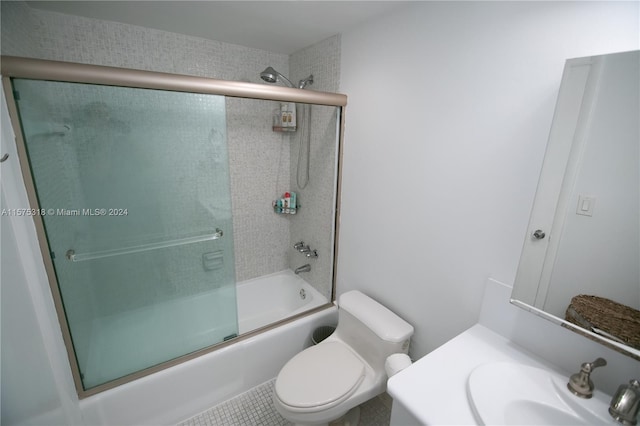 full bathroom featuring enclosed tub / shower combo, sink, toilet, and tile floors