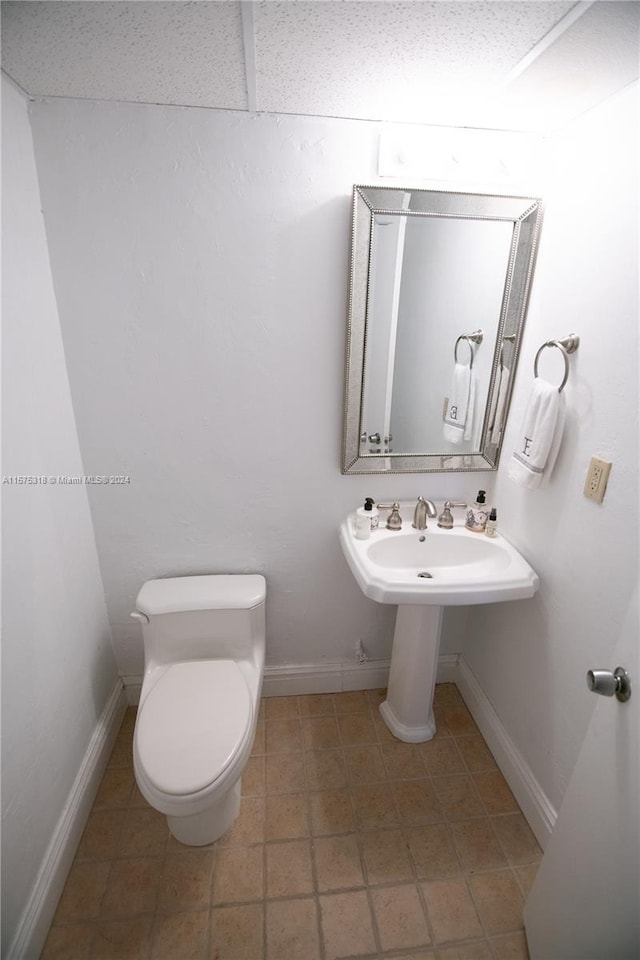 bathroom with toilet and tile flooring