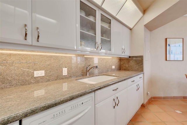 kitchen featuring sink, white cabinetry, decorative backsplash, and dishwasher