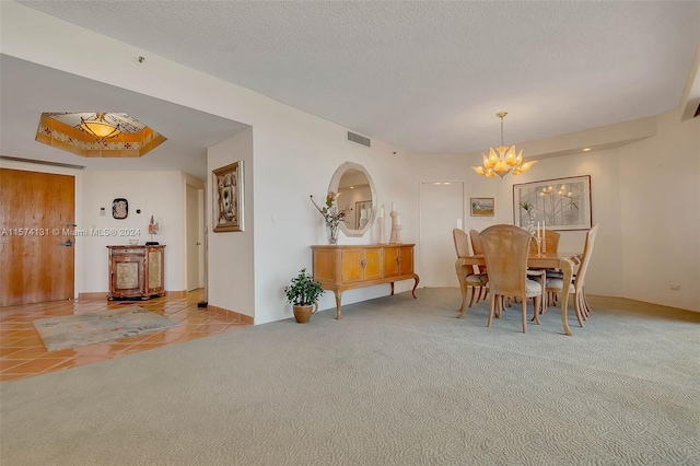 carpeted dining space featuring an inviting chandelier and a textured ceiling