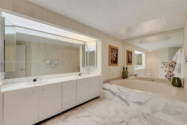 bathroom featuring vanity and tiled tub