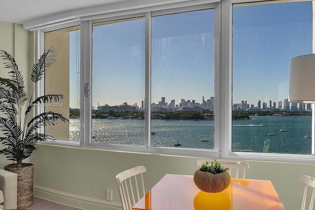 dining area featuring hardwood / wood-style floors and a water view