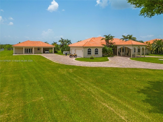 back of property featuring a garage and a lawn