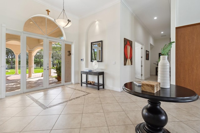 tiled entrance foyer with french doors and crown molding