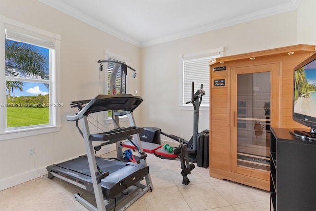 exercise area with ornamental molding and light tile patterned floors