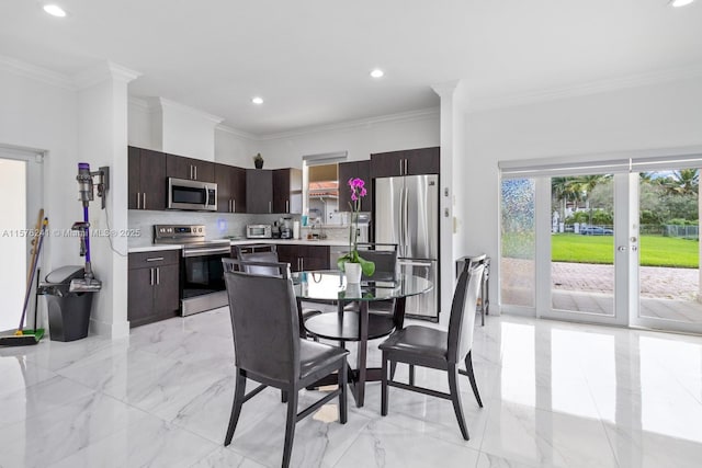 dining area with sink and crown molding