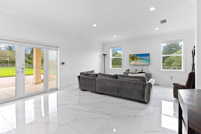 living room featuring a healthy amount of sunlight and ornamental molding